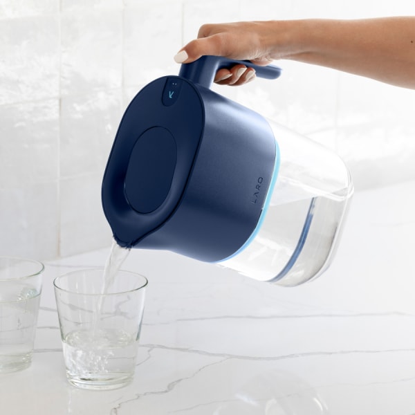 Photo of Larq Pitcher PureVis™ - Monaco Blue pouring water in glass